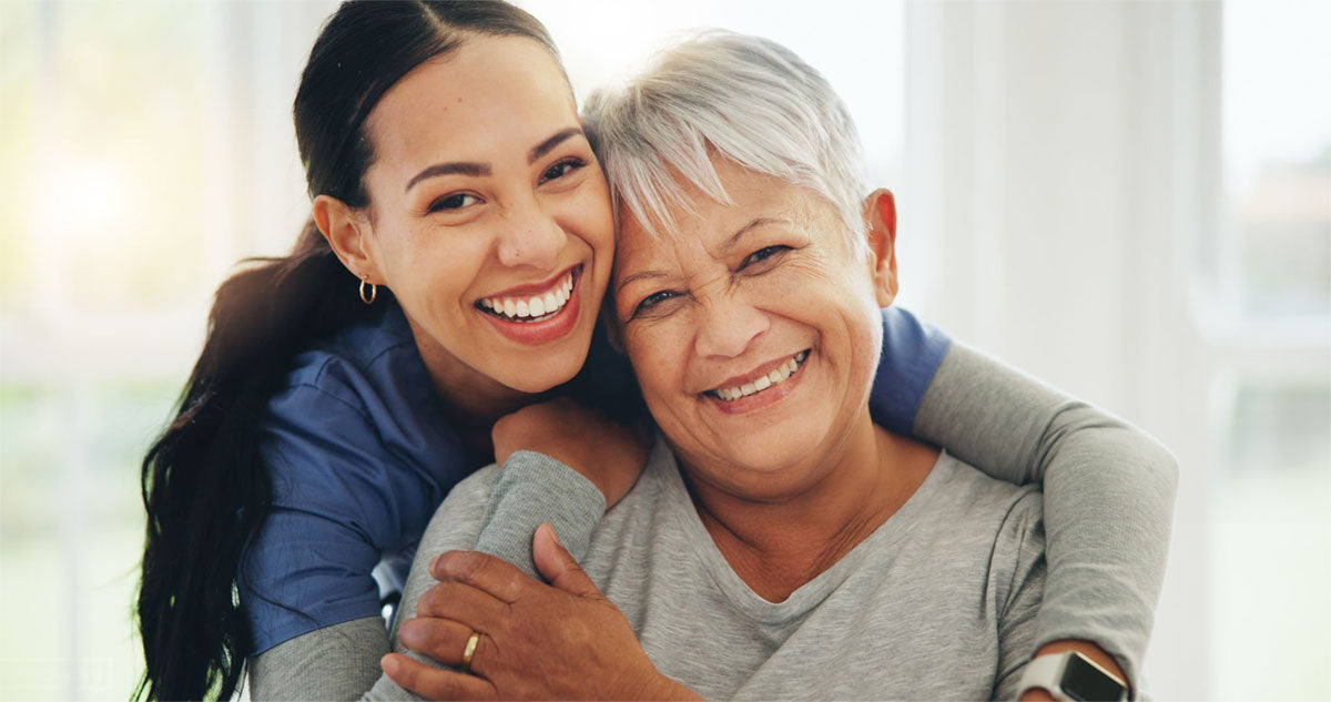A physical therapist happily smiling with her happy patient
