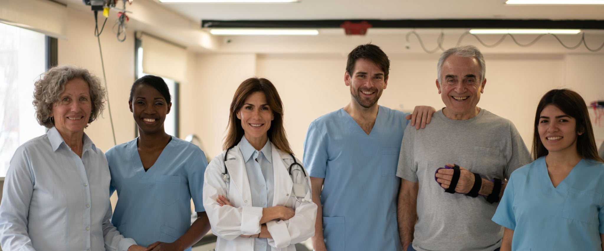 A group of professiona physical therapists, a doctor and a patient